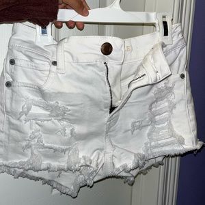 White ripped jean shortie shorts.